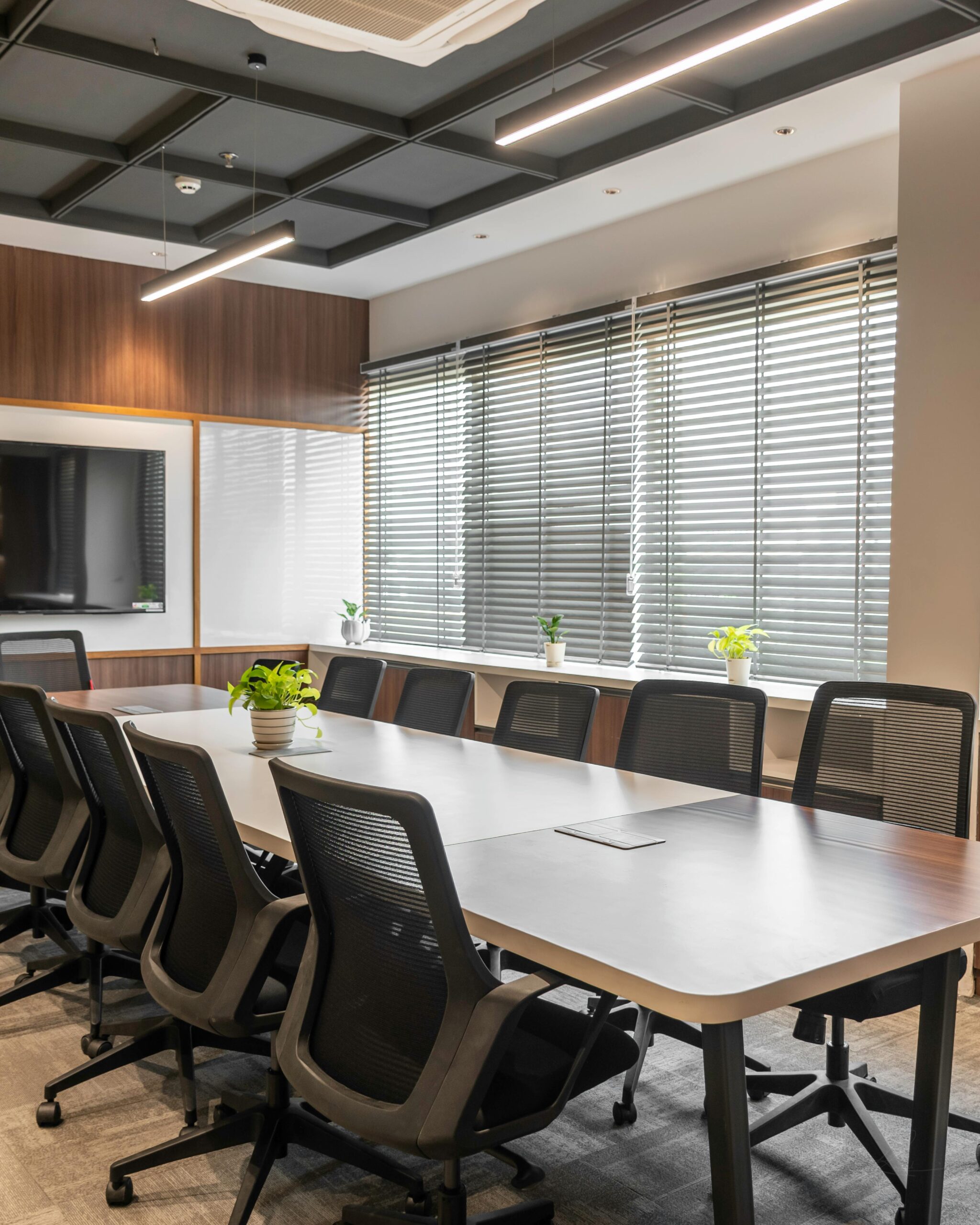 Sleek boardroom with conference table, chairs, and natural lighting in Sahibzada Ajit Singh Nagar.